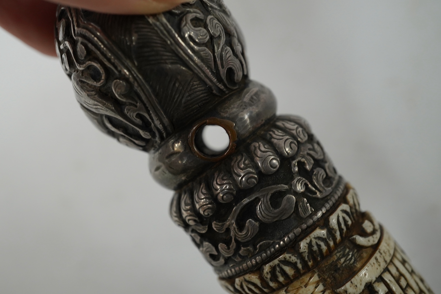 A Tibetan bone and repousse work seal, late 19th/early 20th century, 15cm high. Condition - fair
